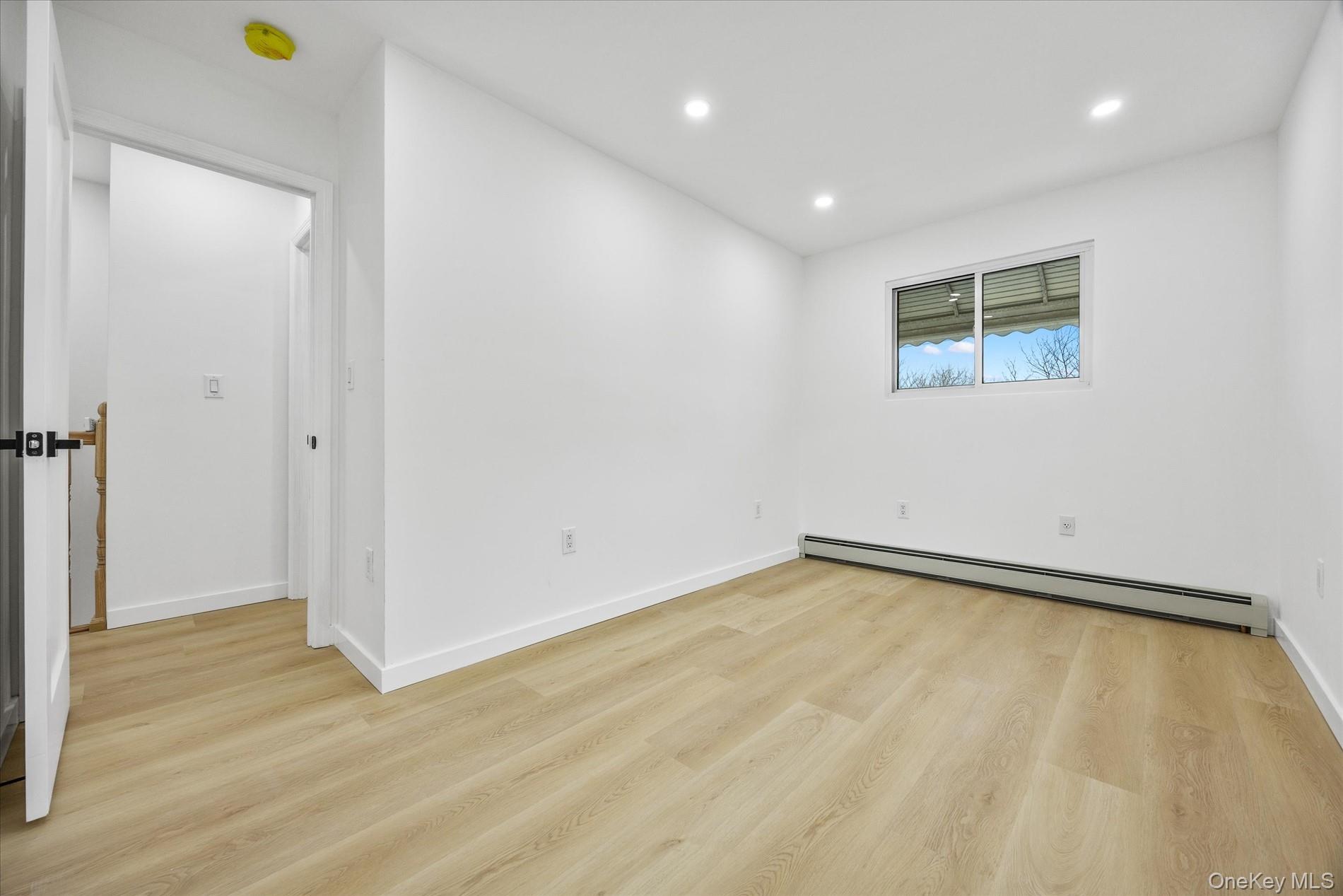 641 Beach 65th Street Queens, NY 11692 - Photo 20 of 34 a view of a room with wooden floor and white walls