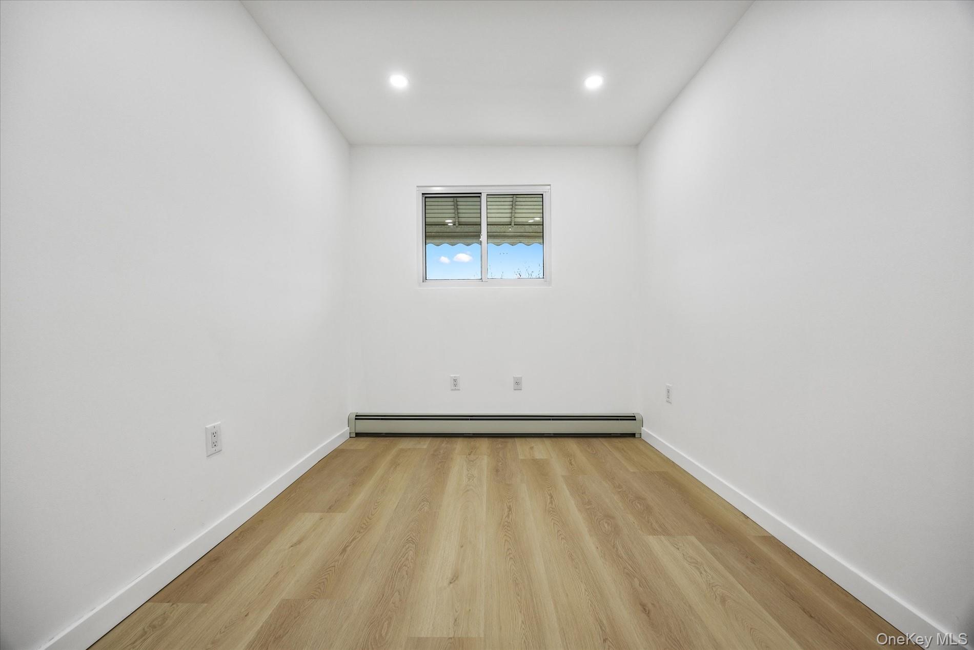 641 Beach 65th Street Queens, NY 11692 - Photo 22 of 34 a view of a room with wooden floor and a window