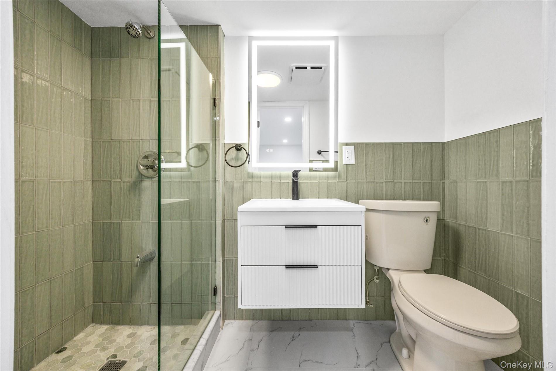 641 Beach 65th Street Queens, NY 11692 - Photo 29 of 34 a bathroom with a sink a toilet and shower