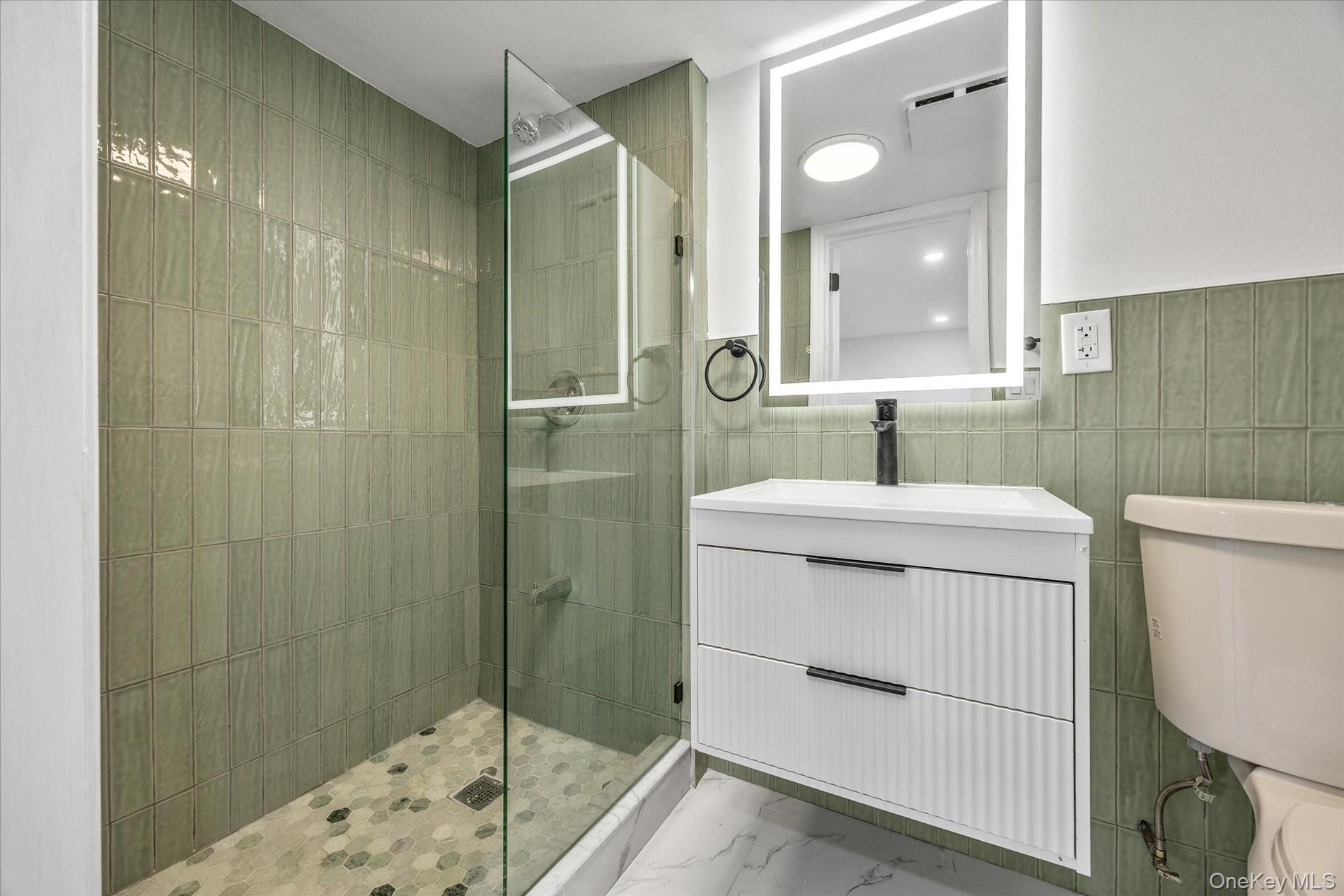 641 Beach 65th Street Queens, NY 11692 - Photo 30 of 34 a bathroom with a sink a toilet and shower