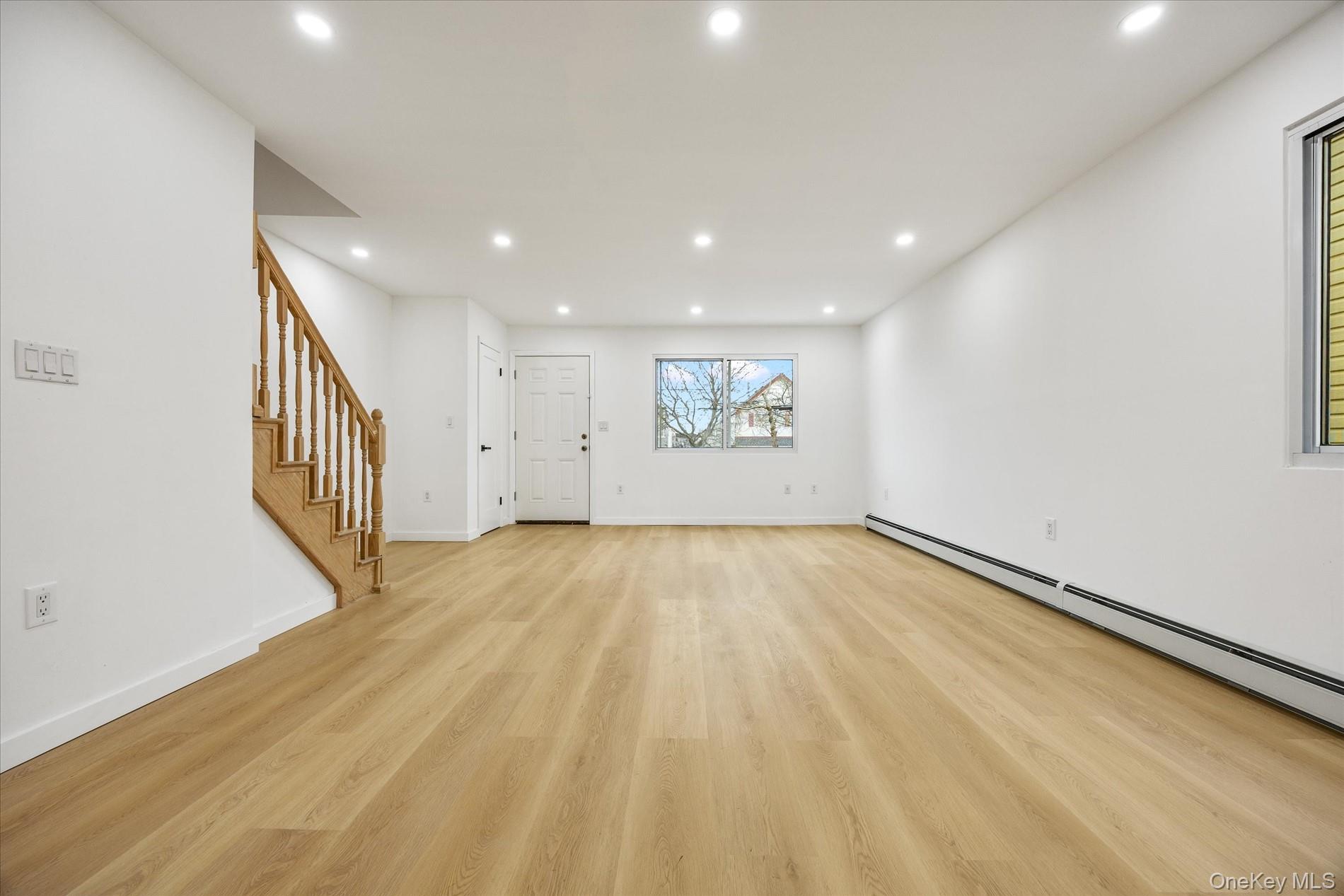 641 Beach 65th Street Queens, NY 11692 - Photo 8 of 34 a view of an empty room with wooden floor and a window