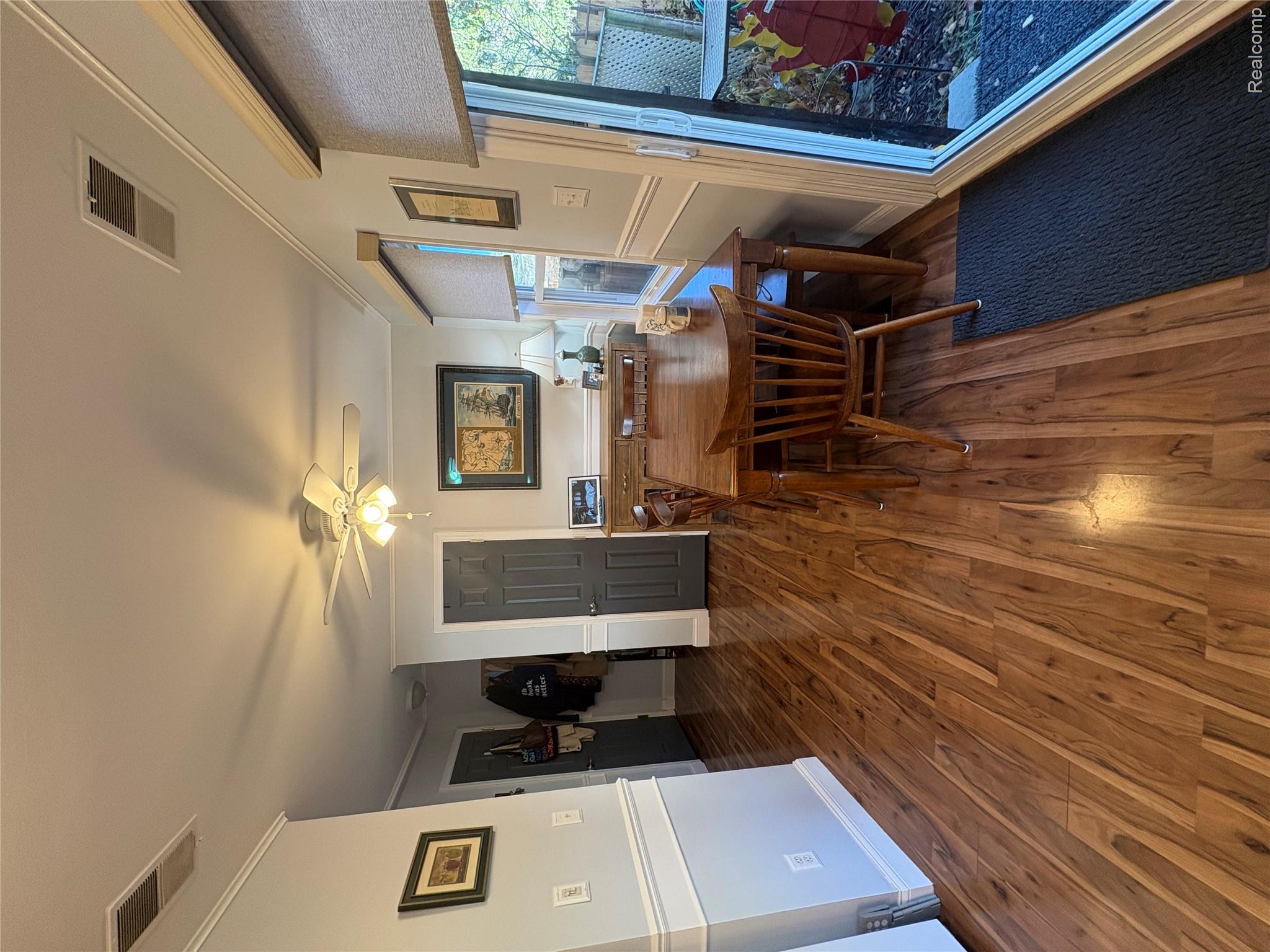 1030 Larson Court Rochester, MI 48307 - Photo 4 of 21 Dining space with crown molding, dark wood finished floors, and a ceiling fan