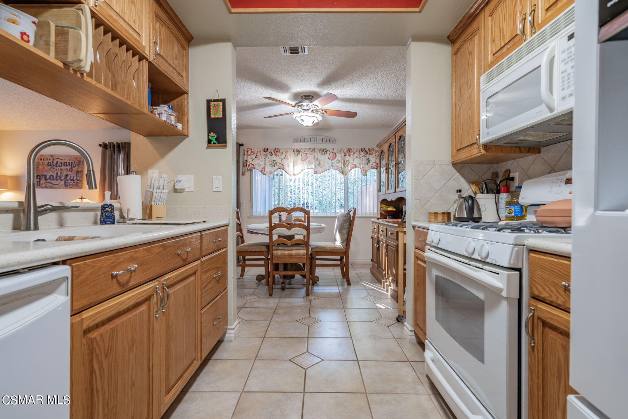2044 Covington Avenue Simi Valley, CA 93065 - Photo 14 of 42 a kitchen with cabinets a sink and appliances