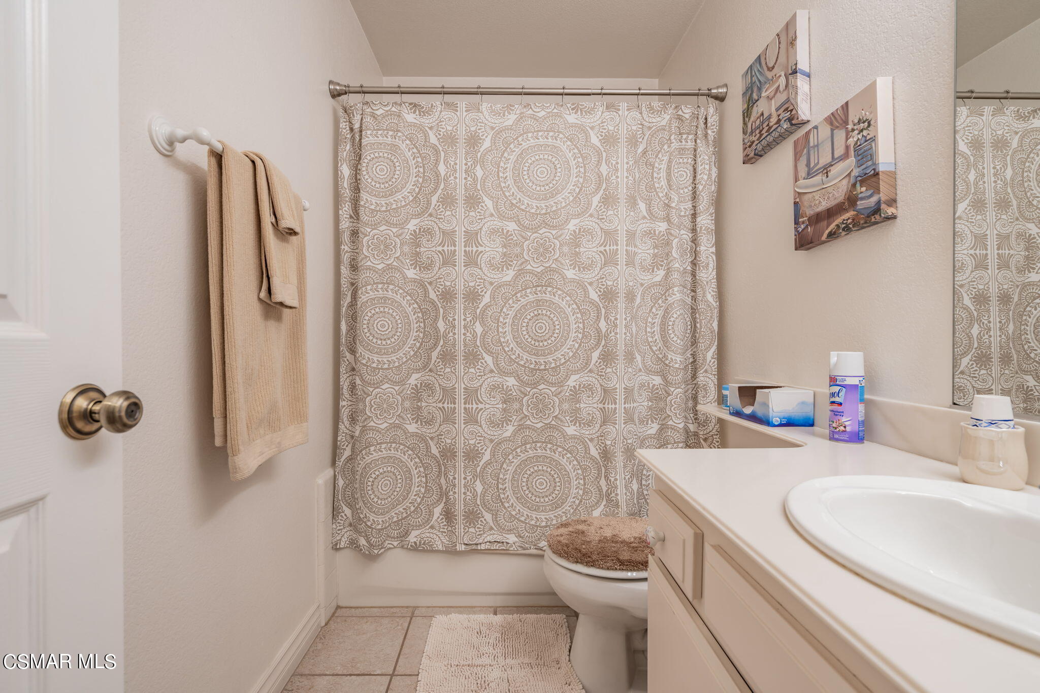 2044 Covington Avenue Simi Valley, CA 93065 - Photo 21 of 42 a bathroom with a sink a toilet and shower curtain