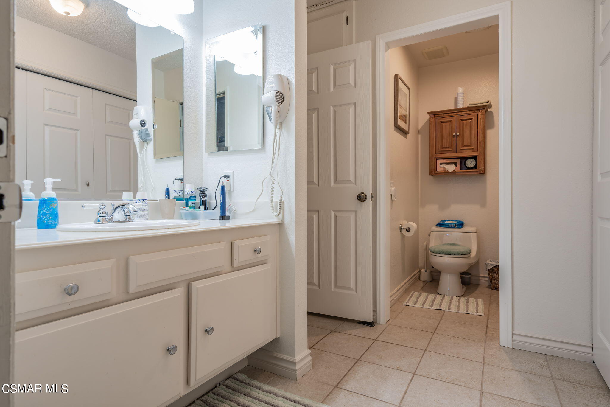 2044 Covington Avenue Simi Valley, CA 93065 - Photo 24 of 42 a bathroom with a sink a toilet and a mirror