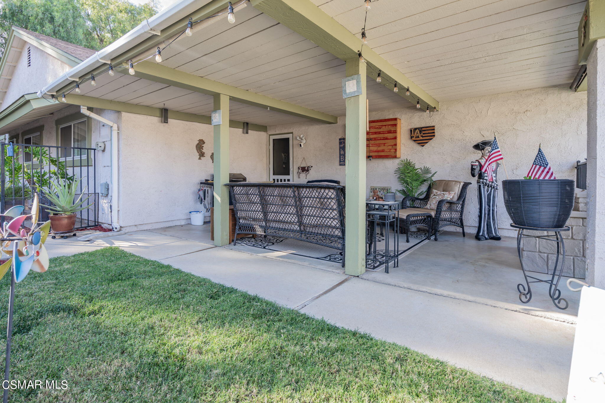 2044 Covington Avenue Simi Valley, CA 93065 - Photo 29 of 42 a view of a patio with table and chairs potted plants with wooden fence