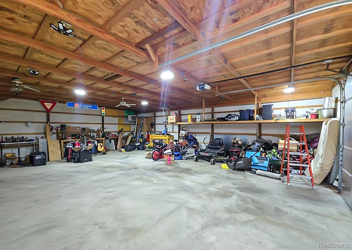 6533 Kilburn Road Jeddo, MI 48032 - Photo 7 of 19 Garage with ceiling fan and a garage door opener
