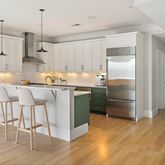 a kitchen with kitchen island a stove a refrigerator and a sink