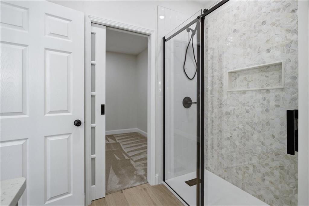4911 Lower Jersey Road Oxford, GA 30054 - Photo 22 of 56 a bathroom with a glass shower door
