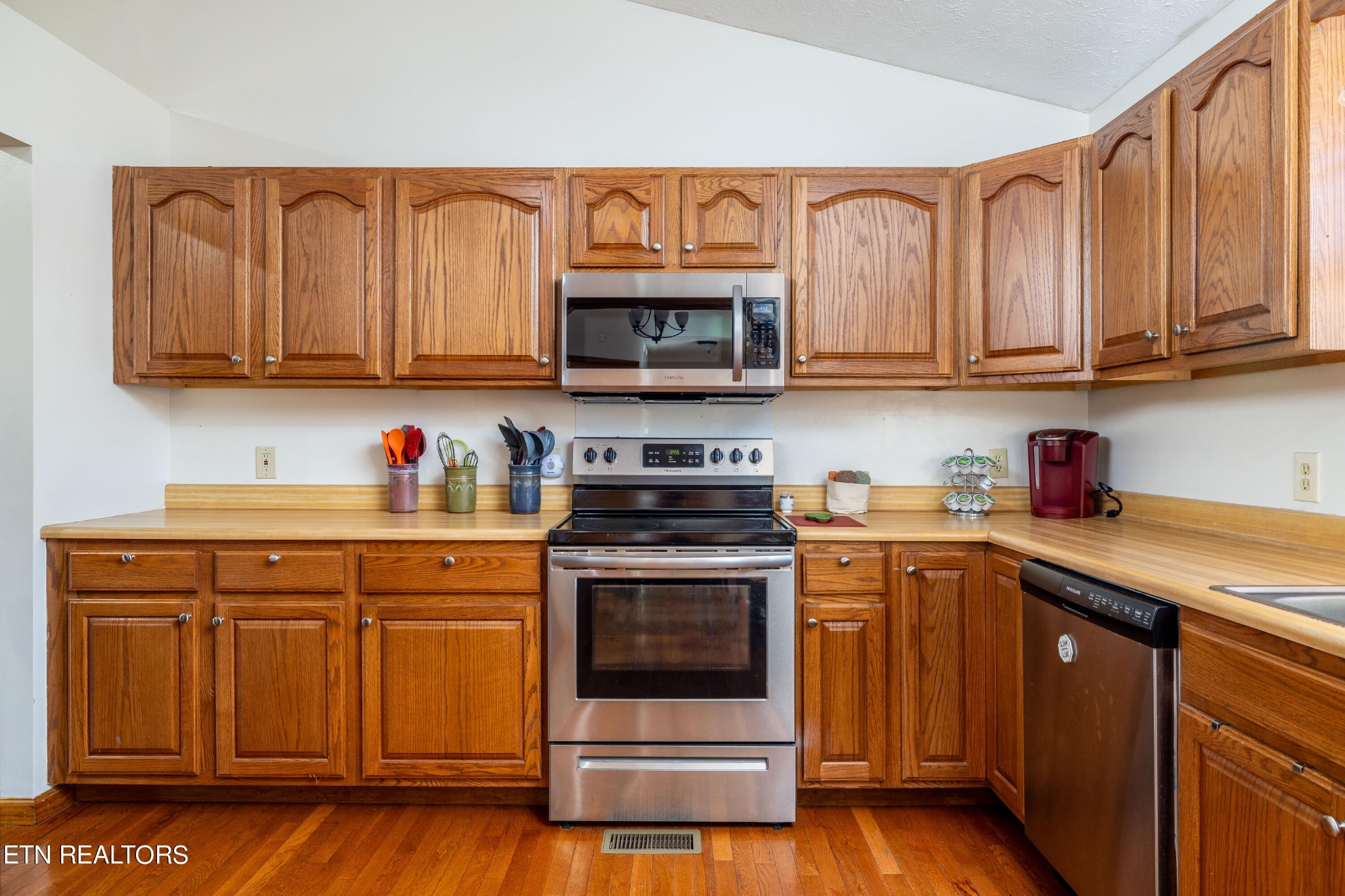 929 Robinson Gap Road Sevierville, TN 37876 - Photo 14 of 28 a kitchen with stainless steel appliances granite countertop a stove a sink and a microwave