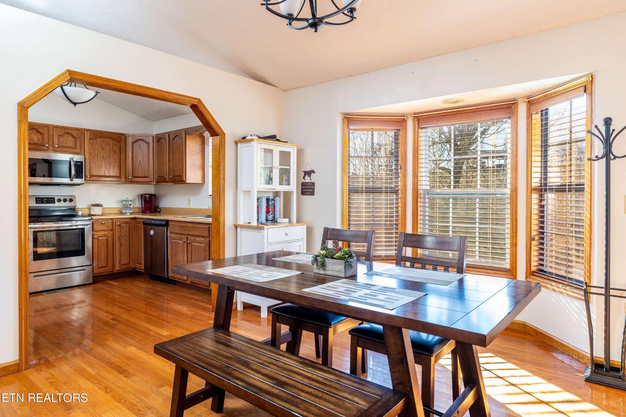 929 Robinson Gap Road Sevierville, TN 37876 - Photo 17 of 28 a kitchen with a table chairs a sink dishwasher window and cabinets