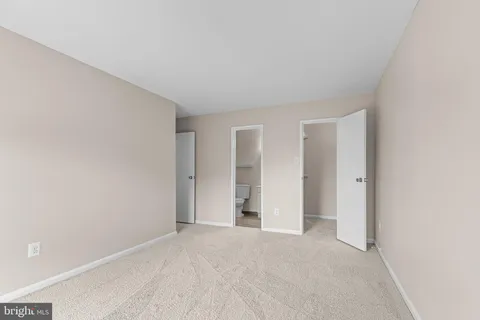 a view of an empty room and closet area