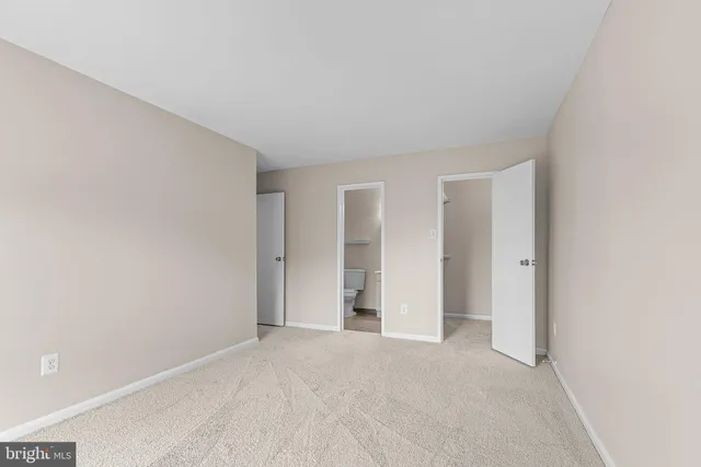 a view of an empty room and closet area
