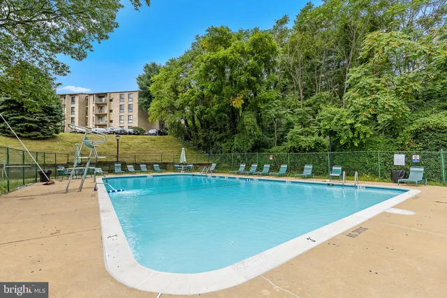 a view of a swimming pool with a lounge chair