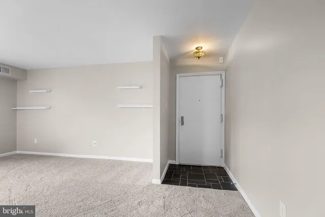 a view of a livingroom with wooden floor and a sink