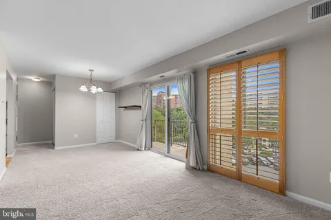 a view of an empty room with glass door