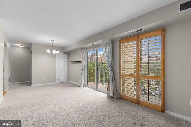 a view of an empty room with glass door