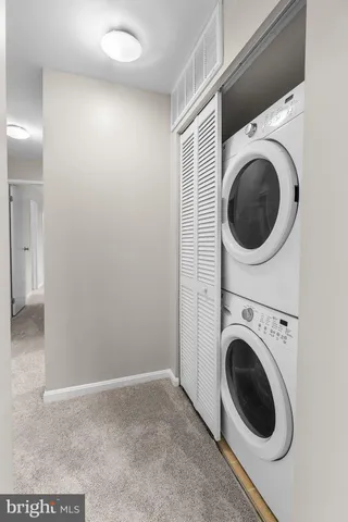 a view of a hallway with washer and dryer