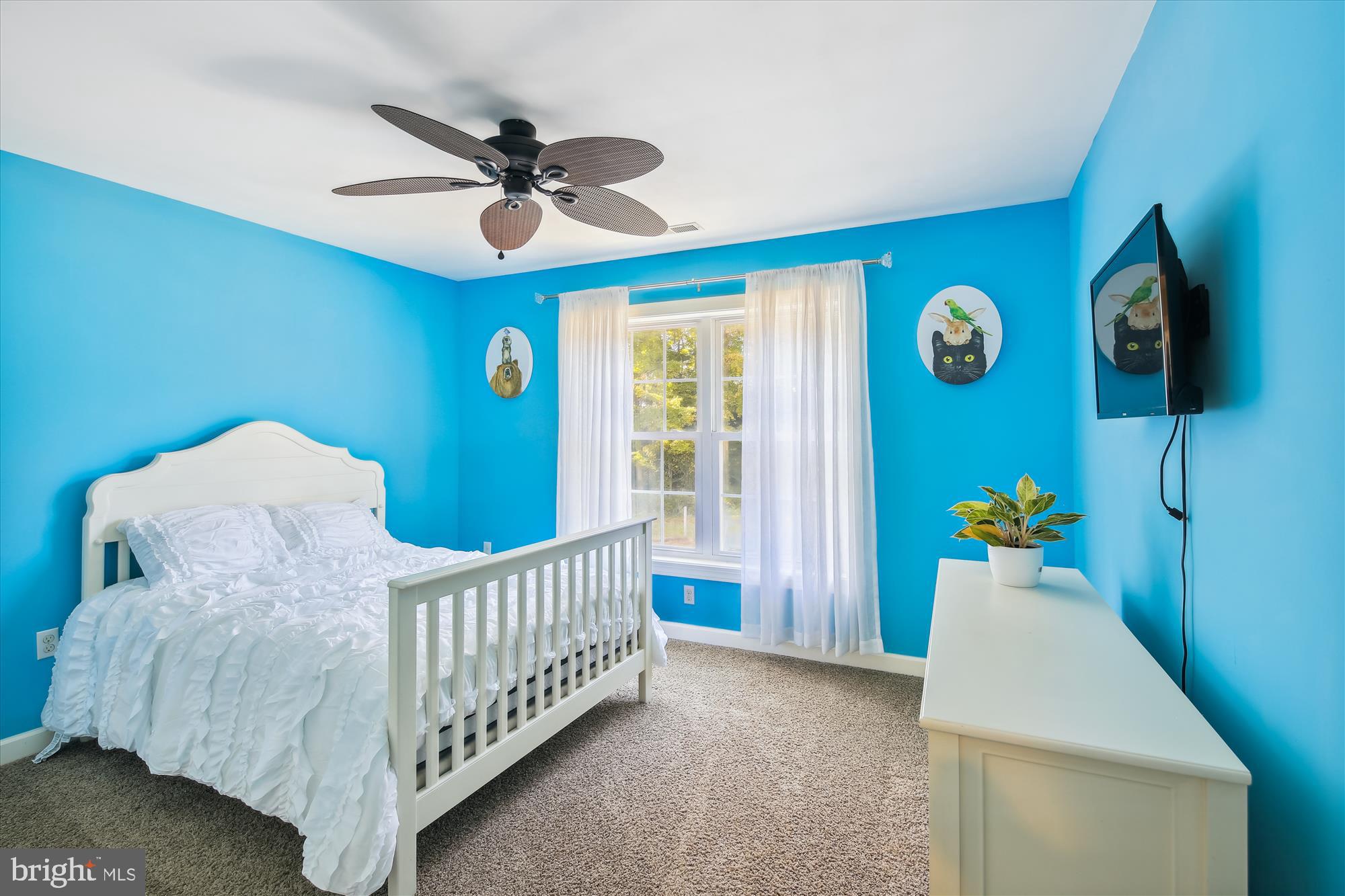 9044 Davis Road Pittsville, MD 21850 - Photo 34 of 43 a bed room with a bed and a chandelier