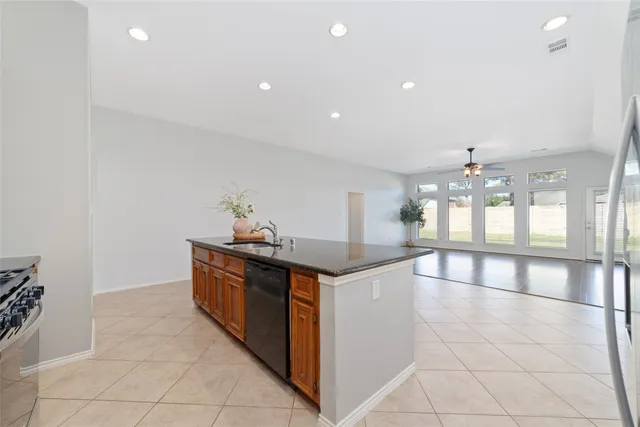 a kitchen with stainless steel appliances a sink stove and cabinets