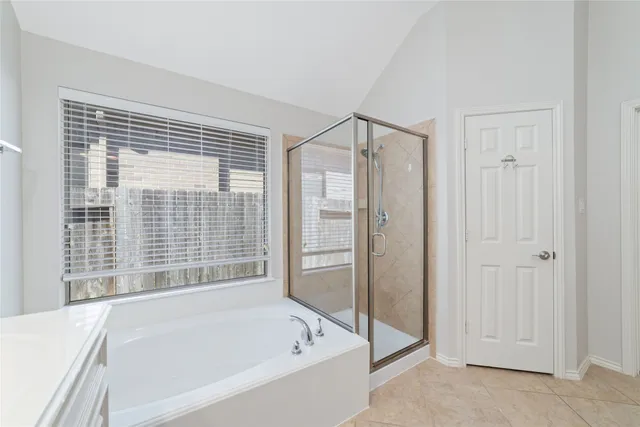 a bathroom with a bathtub and a shower