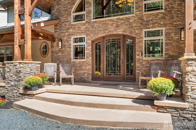 a kitchen with stainless steel appliances granite countertop a stove and a large window