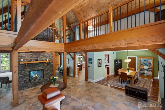 a dining room with furniture a floor to ceiling window and a rug