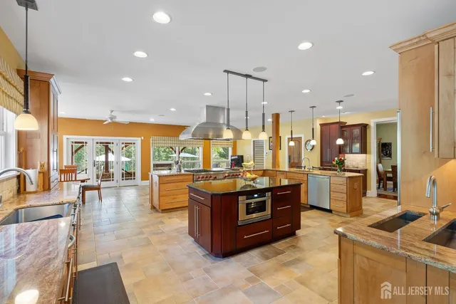 a spacious bedroom with a bed and a chandelier