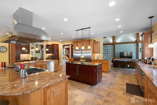 a kitchen with stainless steel appliances granite countertop a sink and a stove