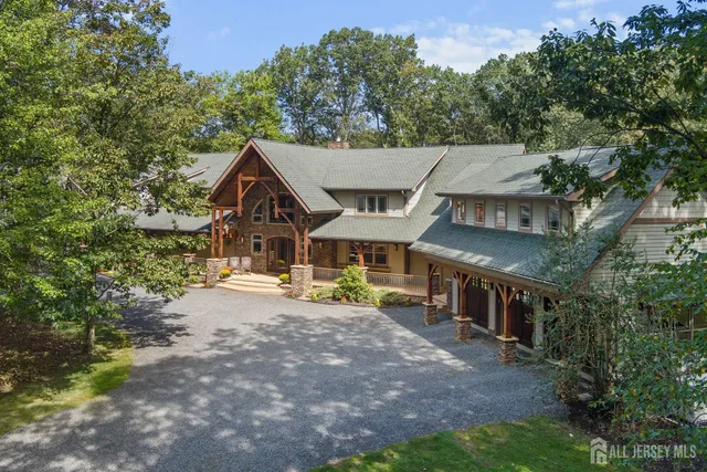 a front view of a house with glass windows and a yard