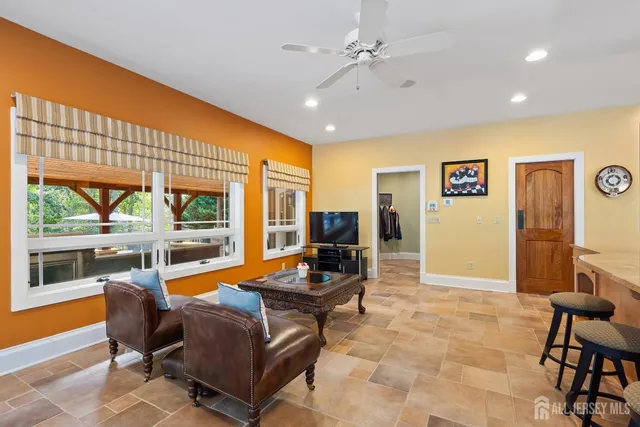 a spacious bathroom with a granite countertop sink a mirror and a bathtub