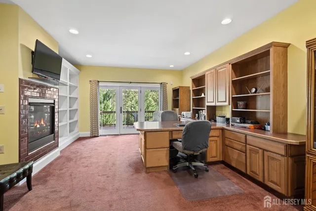 a living room with furniture kitchen view and a large window