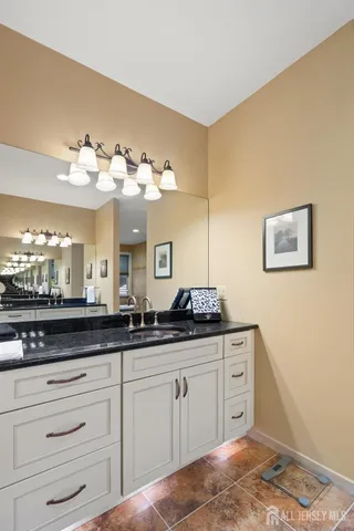 a kitchen with stainless steel appliances kitchen island granite countertop a stove and a sink