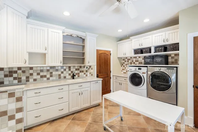 a bedroom with a bed windows and a chandelier