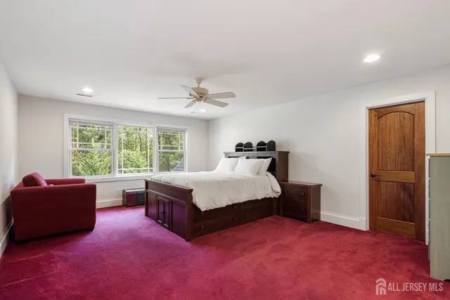 a view of a white house with a big yard and large trees