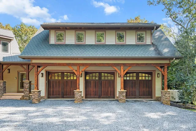 a view of a patio with table and chairs with wooden floor and fence