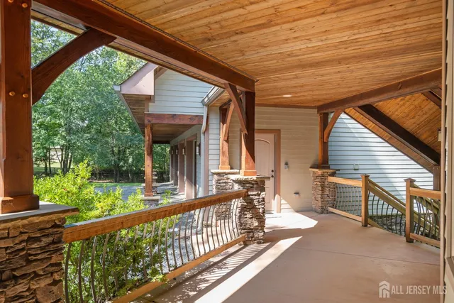 a dining hall with stainless steel appliances kitchen island granite countertop a table chairs and a view of living room