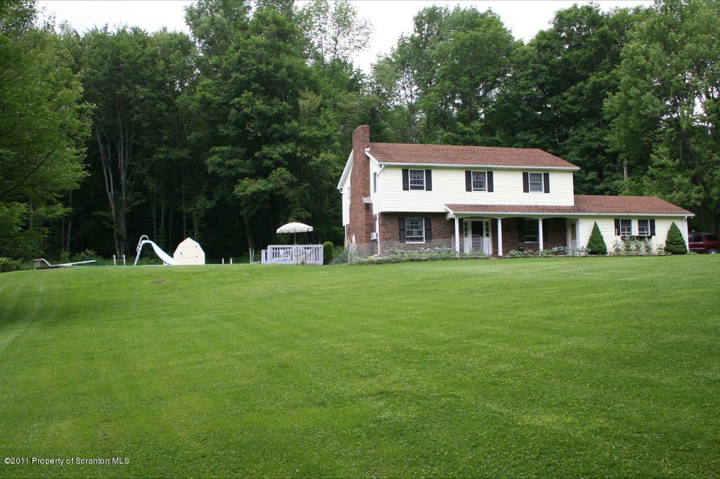 2155 Mccarty Road Nicholson, PA 18446 - Photo 3 of 40 a front view of a house with a yard table and trees