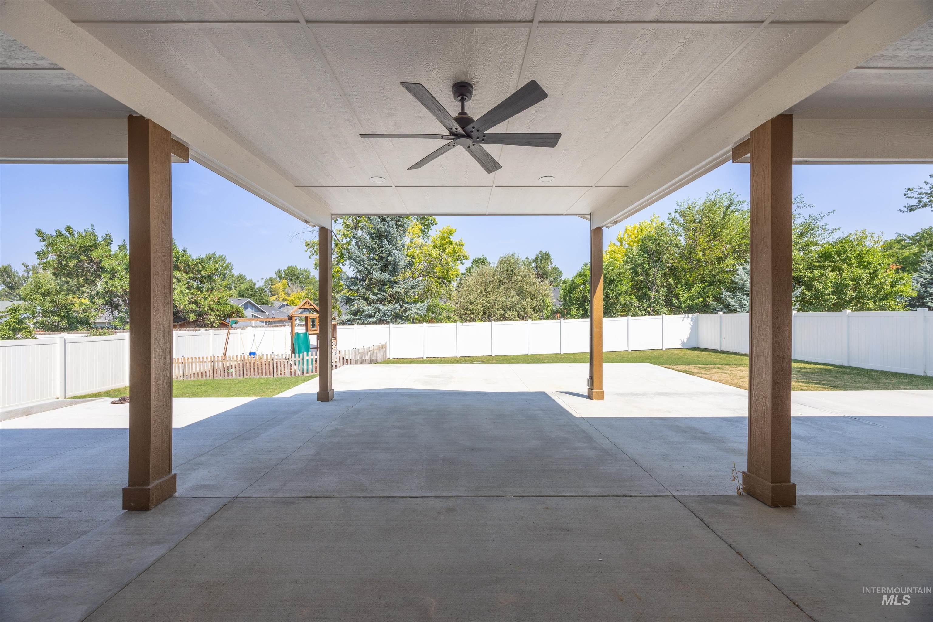300 South Rocker Avenue Kuna, ID 83634 - Photo 38 of 49 Expansive covered patio featuring a ceiling fan, concrete flooring, and substantial support columns