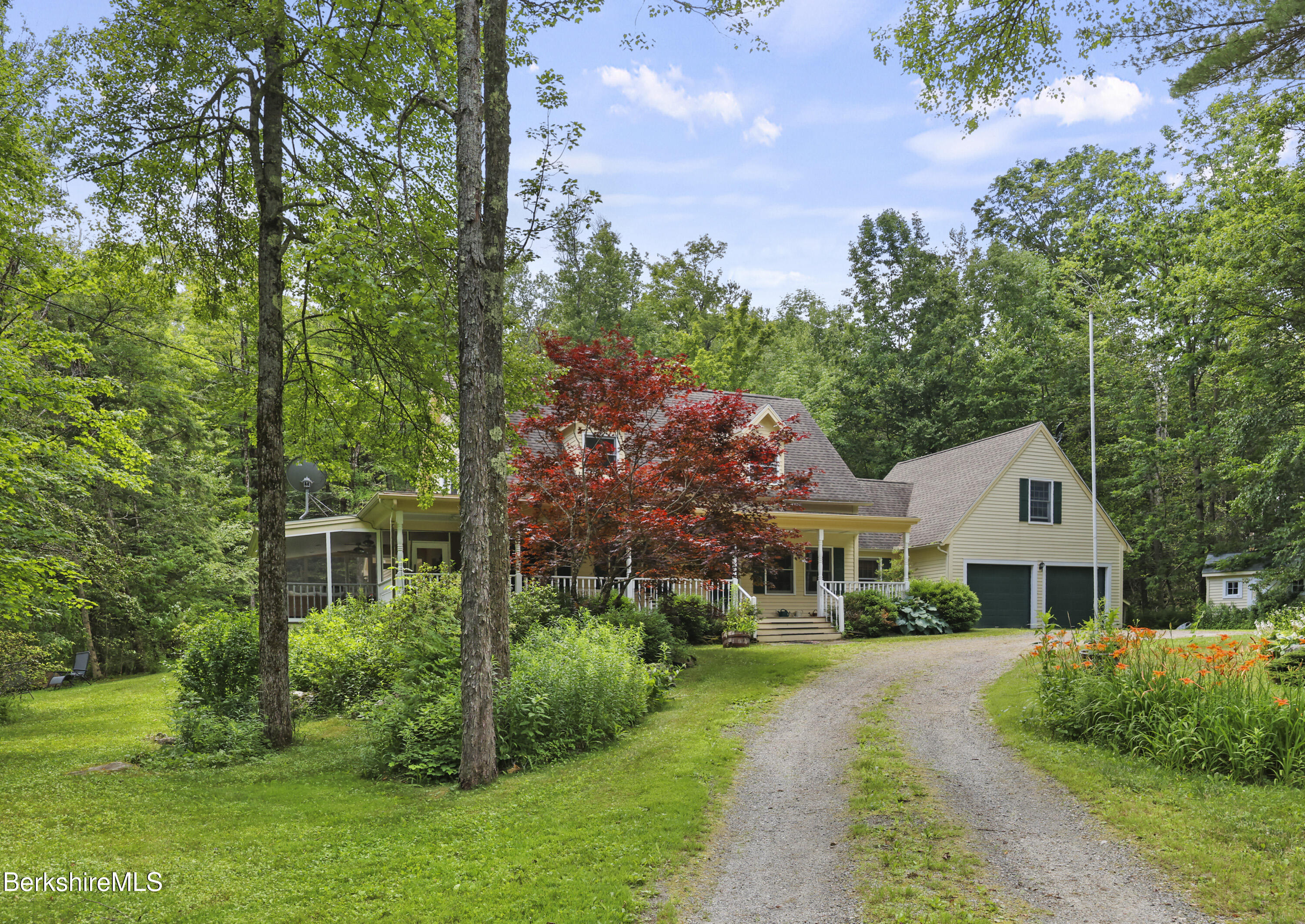 169 Jacobs Hollow Road Becket, MA 01223 - Photo 2 of 73 a front view of a house with a yard and trees