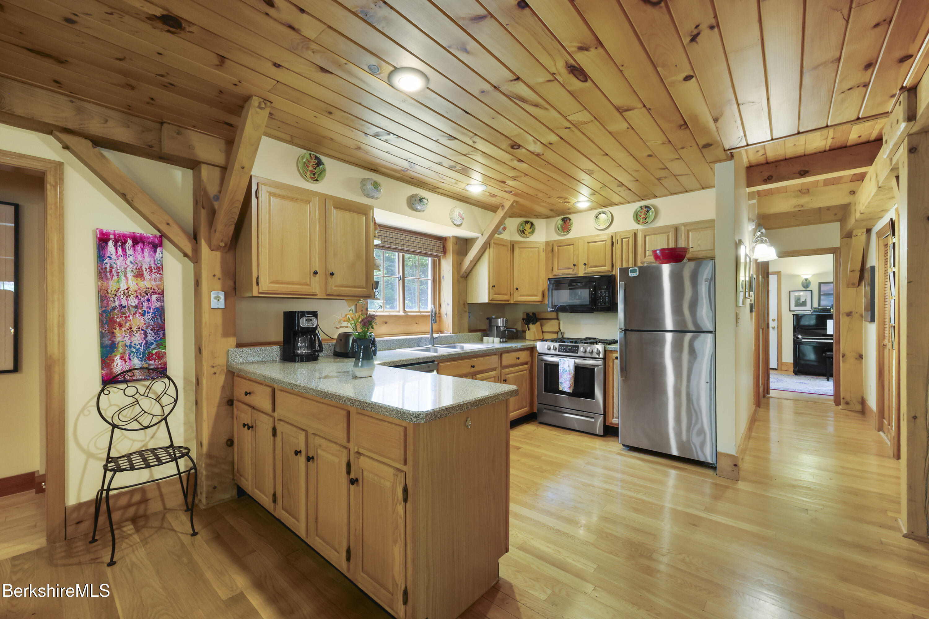 169 Jacobs Hollow Road Becket, MA 01223 - Photo 22 of 73 a kitchen with cabinets and wooden floor
