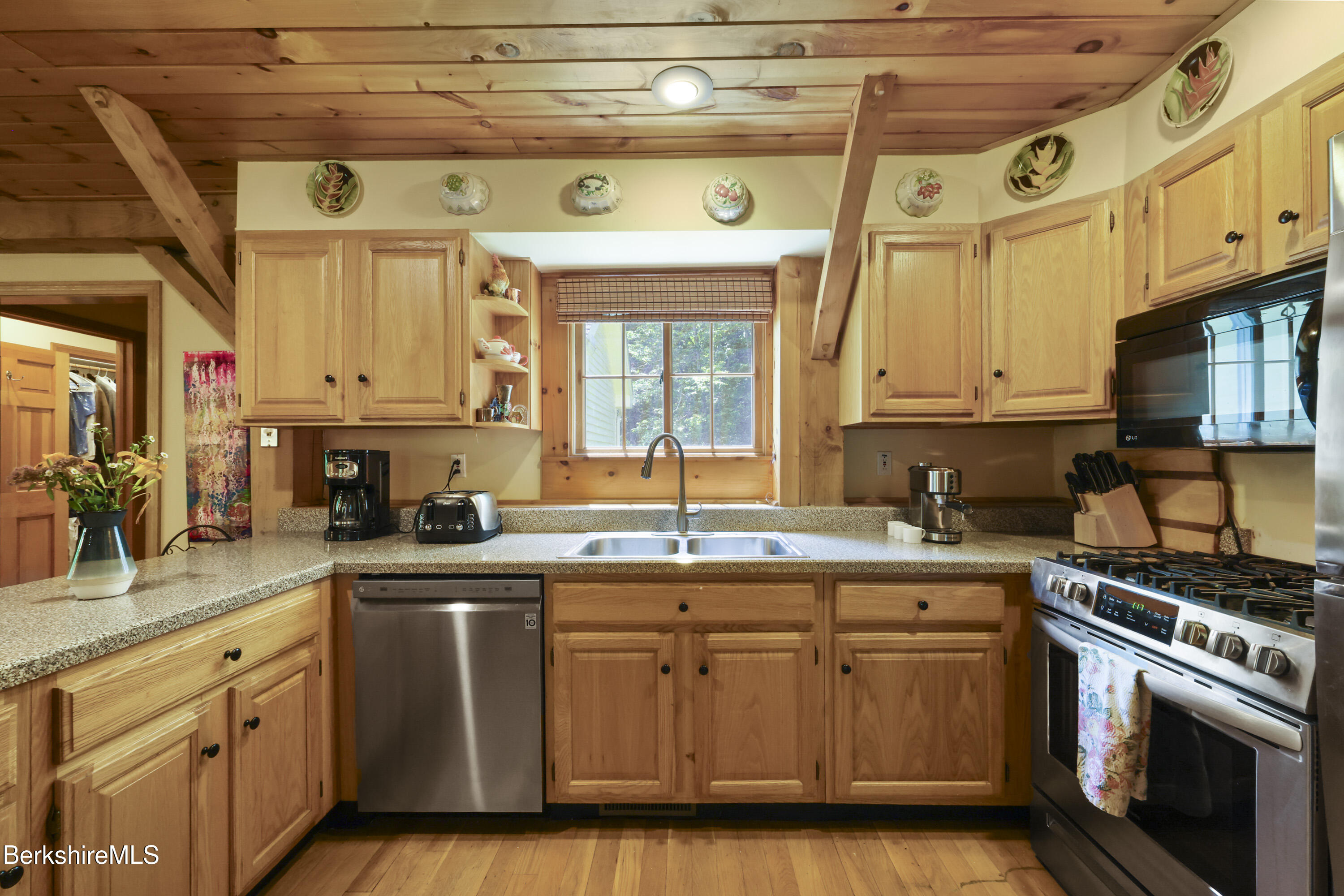 169 Jacobs Hollow Road Becket, MA 01223 - Photo 25 of 73 a kitchen with stainless steel appliances granite countertop a sink a stove and cabinets