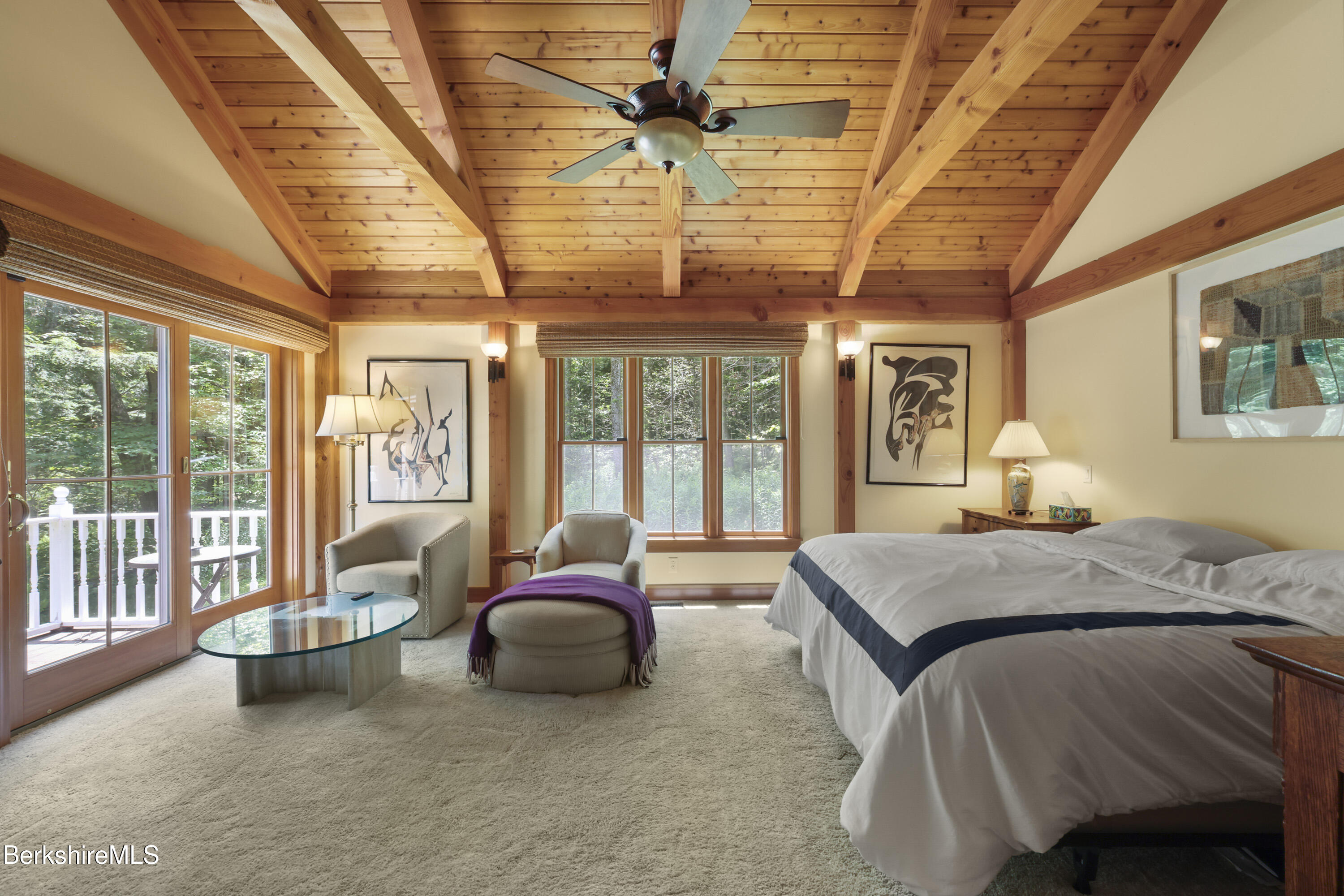 169 Jacobs Hollow Road Becket, MA 01223 - Photo 32 of 73 a spacious bedroom with a bed couch and a ceiling fan