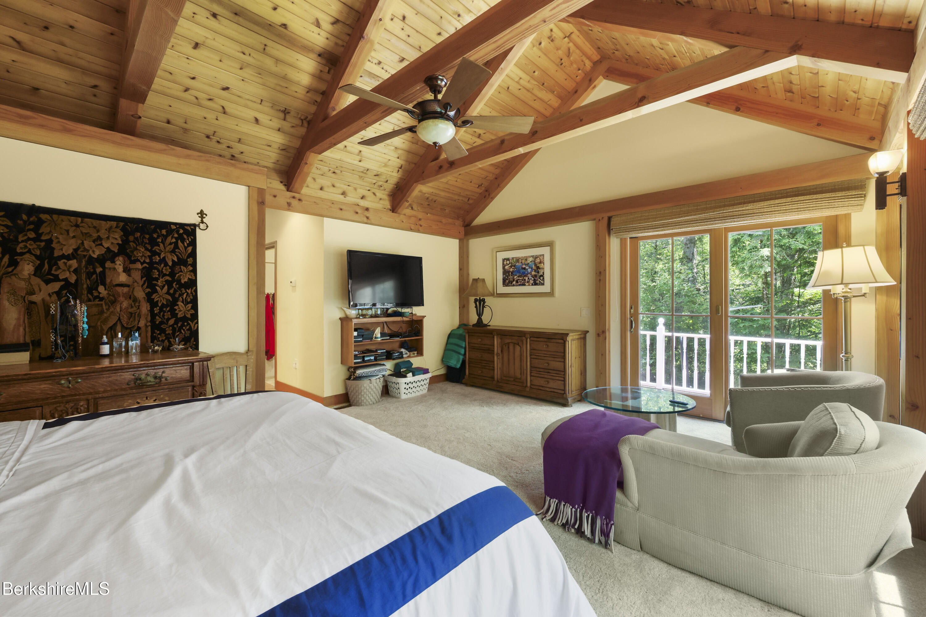 169 Jacobs Hollow Road Becket, MA 01223 - Photo 35 of 73 a living room with furniture a flat screen tv and a large window