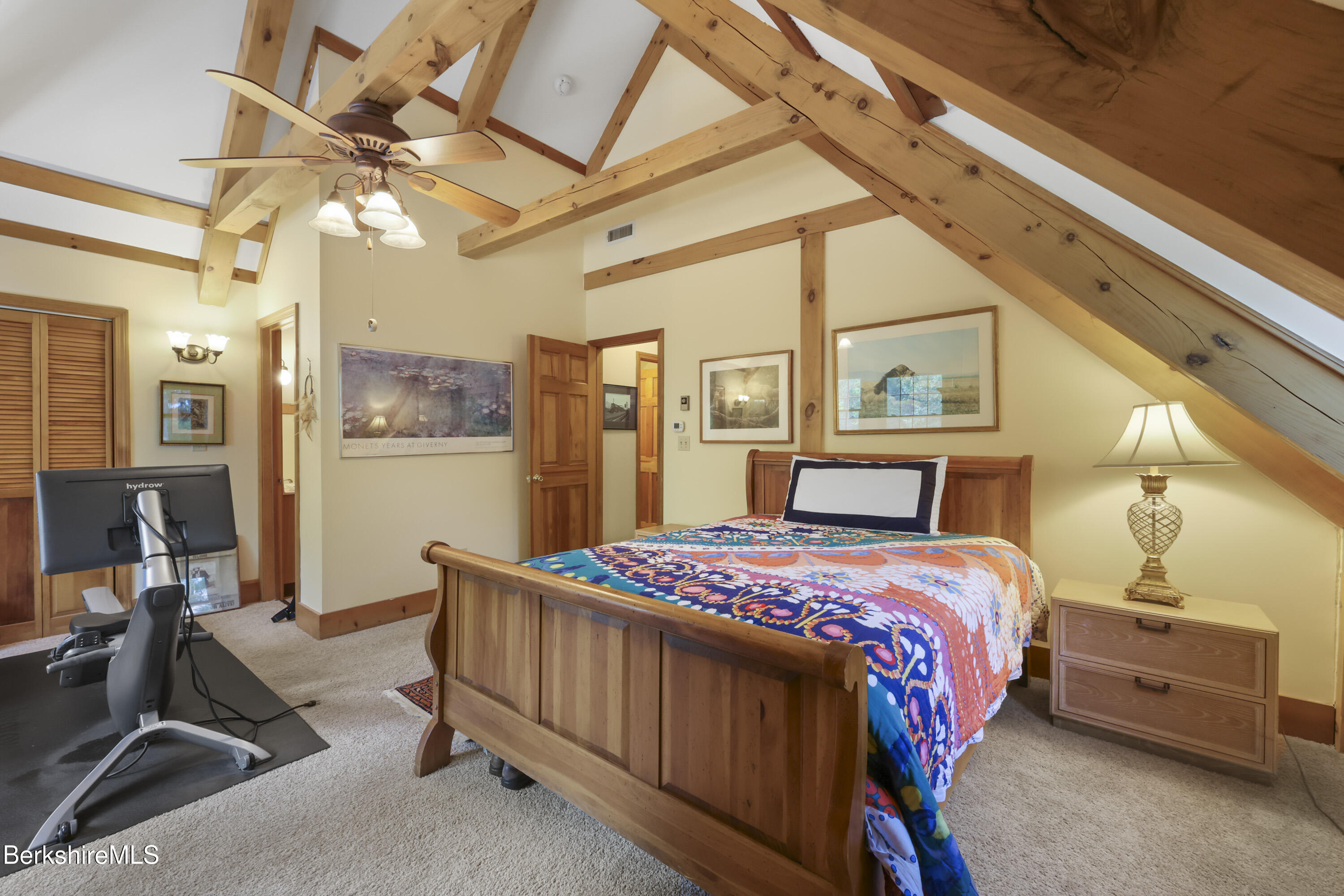 169 Jacobs Hollow Road Becket, MA 01223 - Photo 48 of 73 a bedroom with a bed and a chandelier