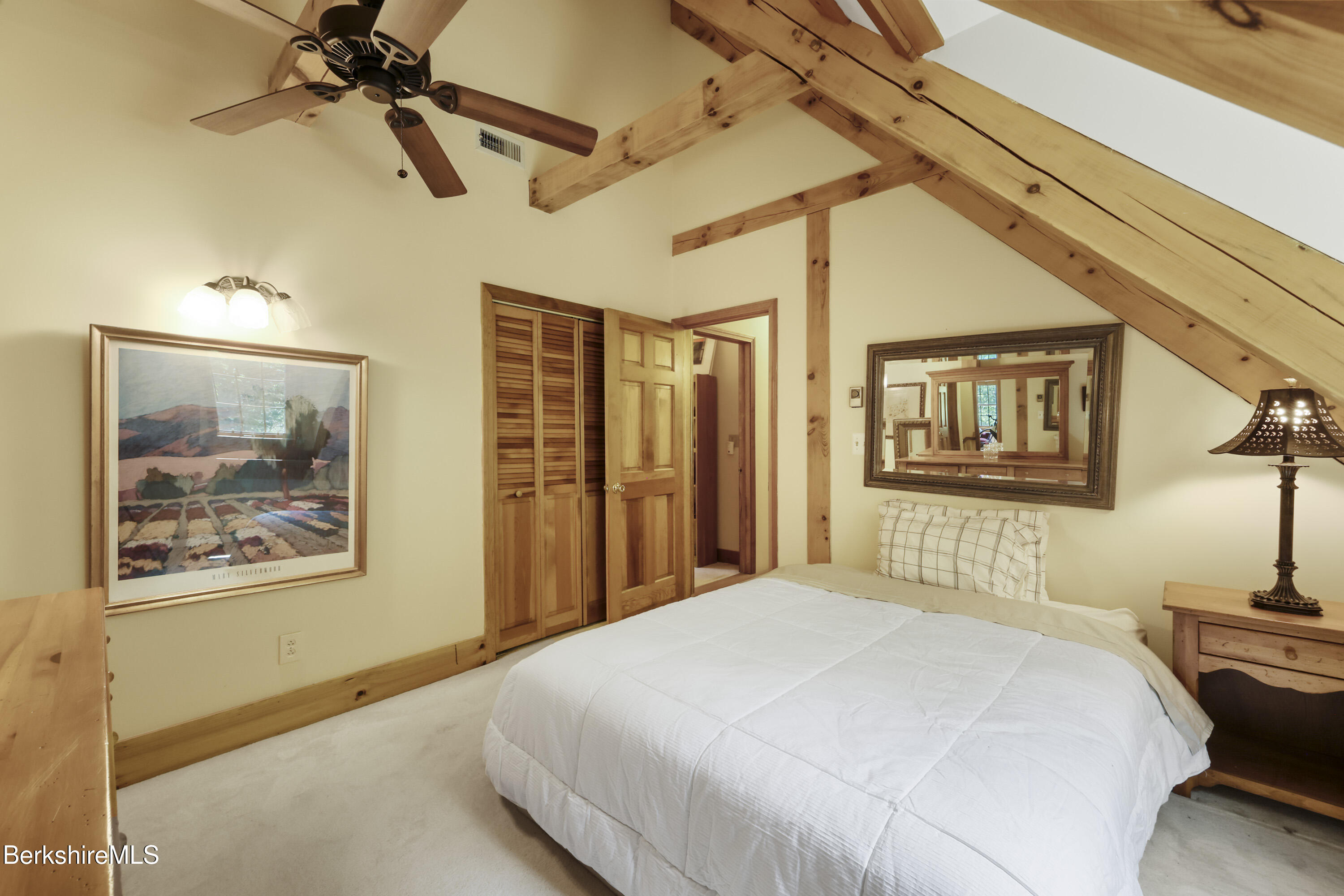 169 Jacobs Hollow Road Becket, MA 01223 - Photo 52 of 73 a bedroom with a bed and a painting on the wall