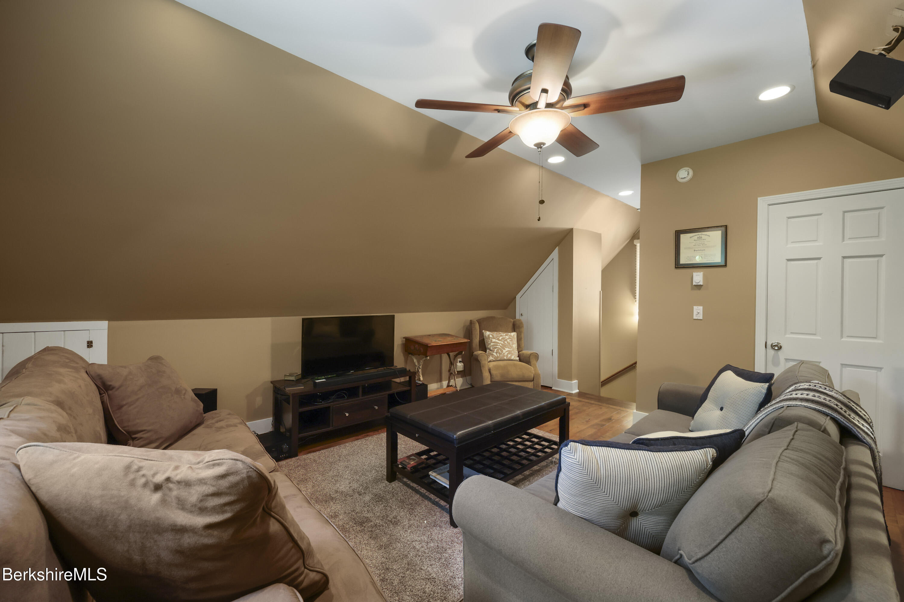 169 Jacobs Hollow Road Becket, MA 01223 - Photo 60 of 73 a living room with furniture a ceiling fan and a rug