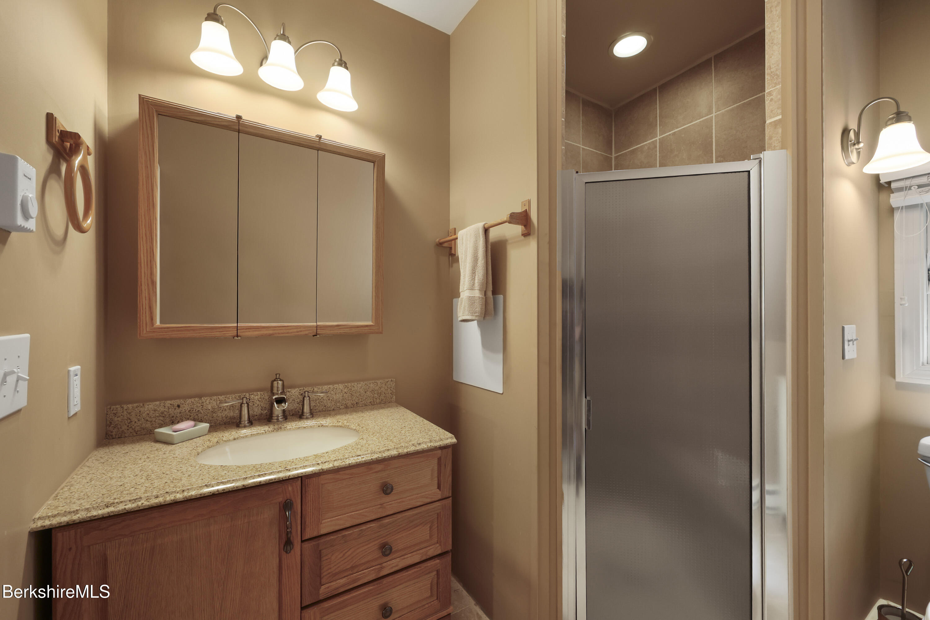 169 Jacobs Hollow Road Becket, MA 01223 - Photo 63 of 73 a bathroom with a granite countertop sink shower and a mirror
