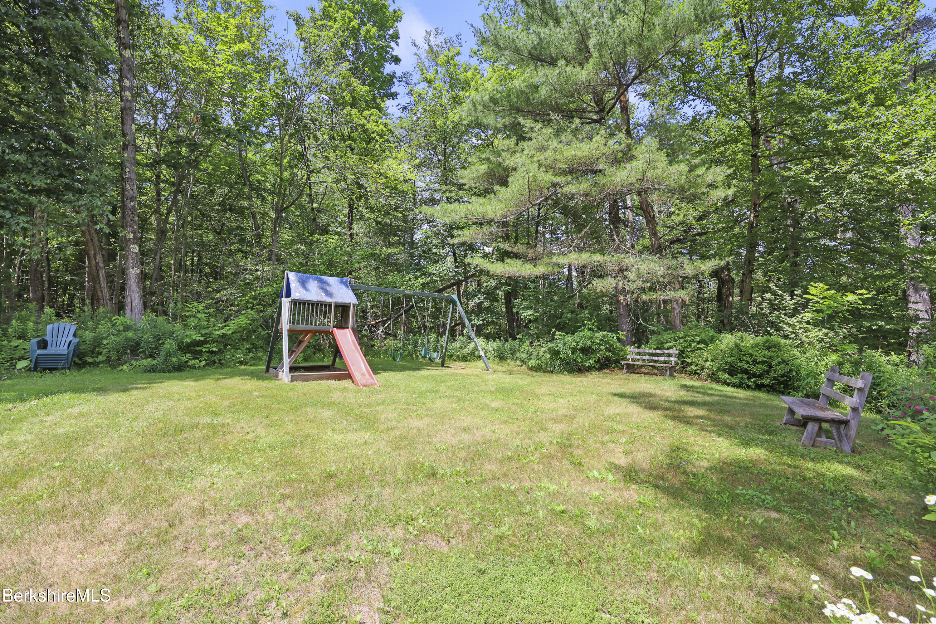169 Jacobs Hollow Road Becket, MA 01223 - Photo 64 of 73 a backyard of a house with a table and chairs