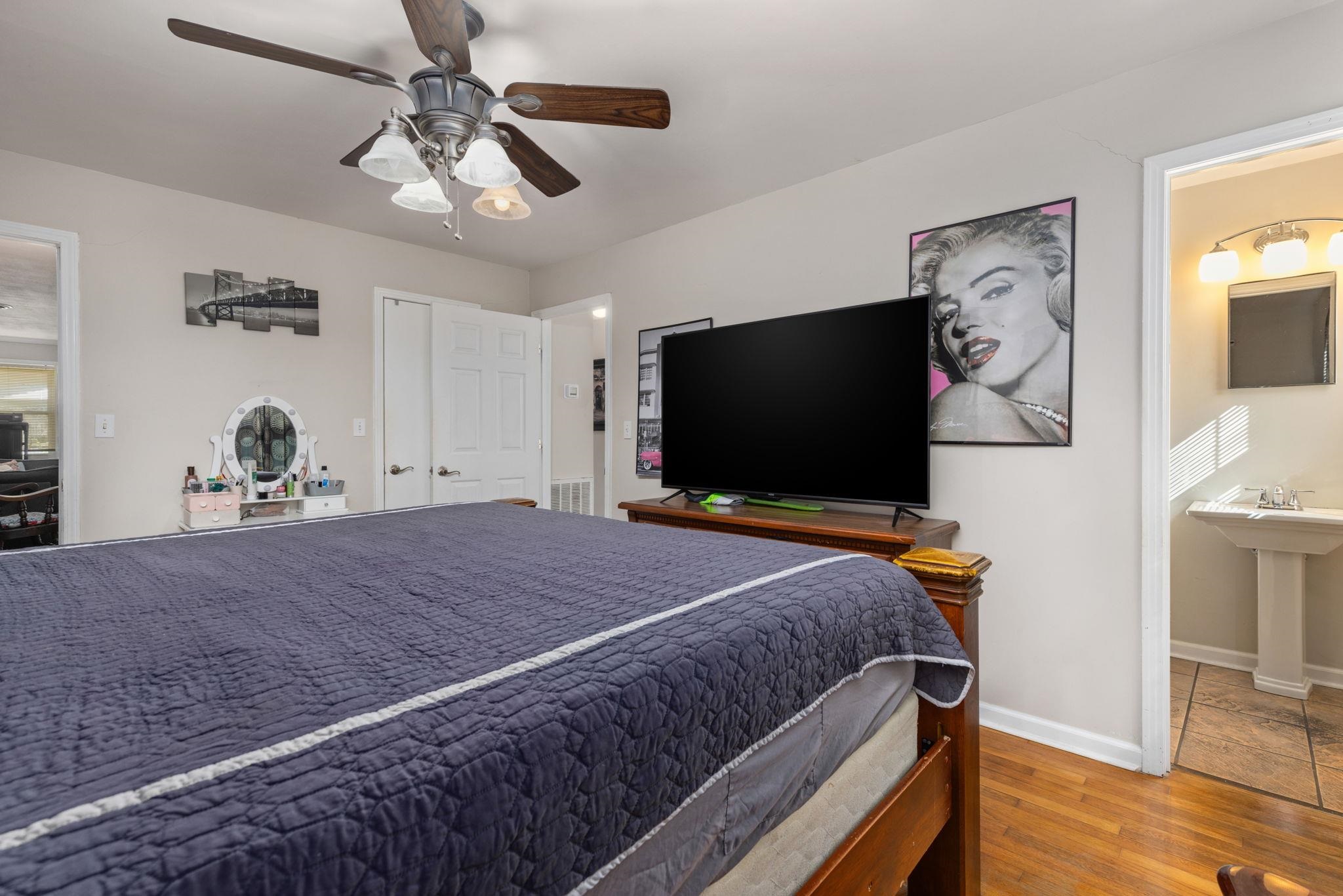 102 West 5th Street Iuka, MS 38852 - Photo 8 of 33 a bedroom with a bed and a flat screen tv